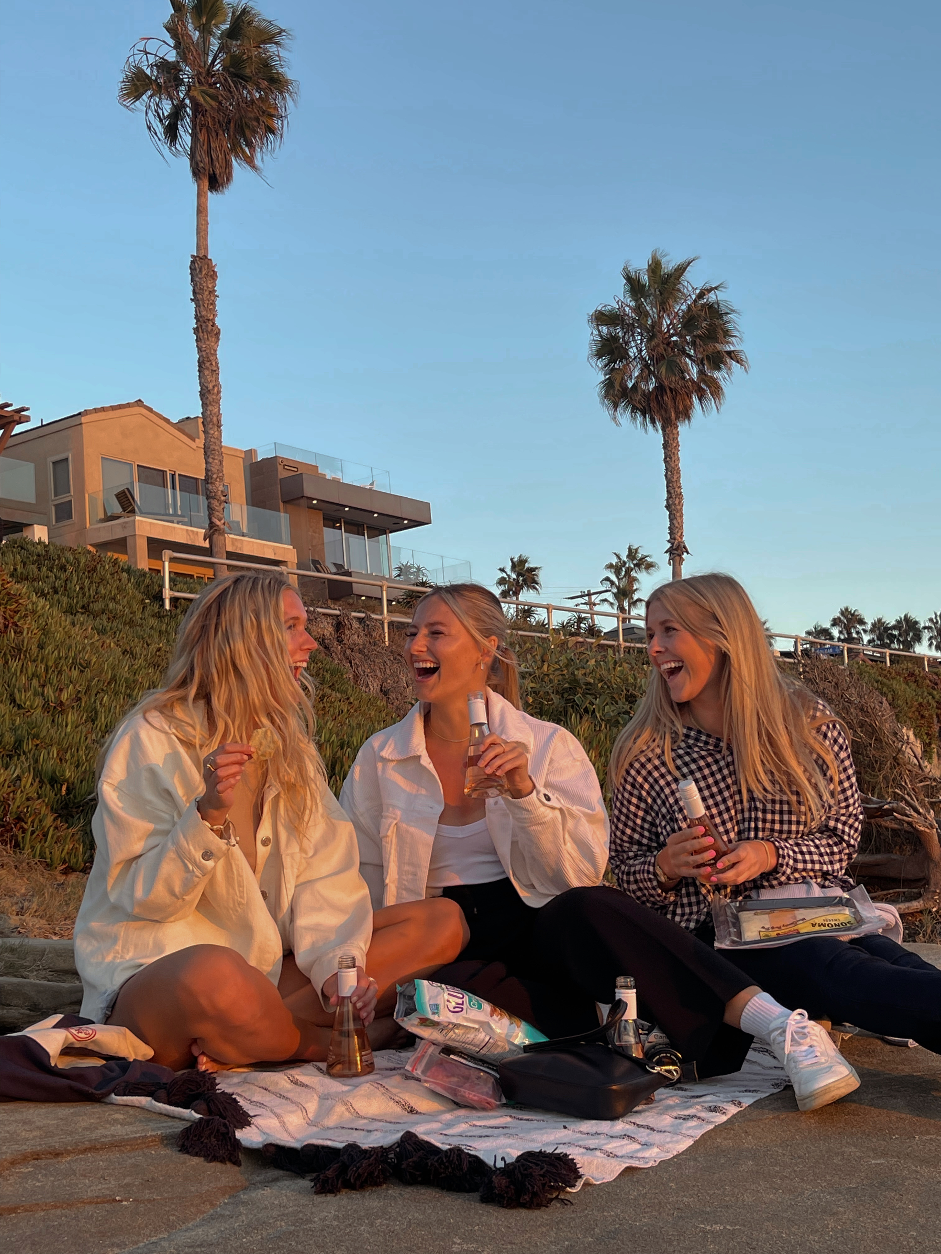 Friends relaxing together outdoors at sunset